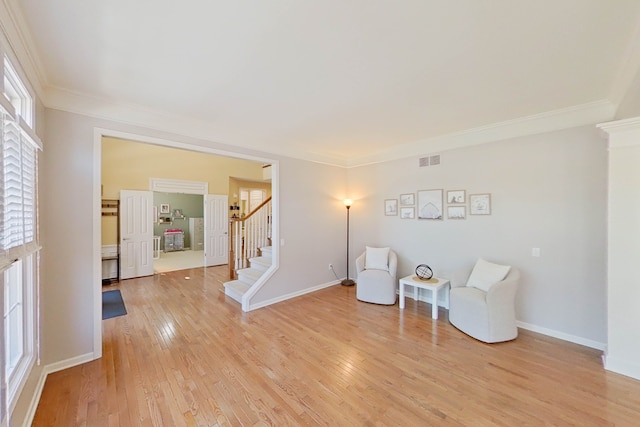 sitting room featuring crown molding and light hardwood / wood-style floors