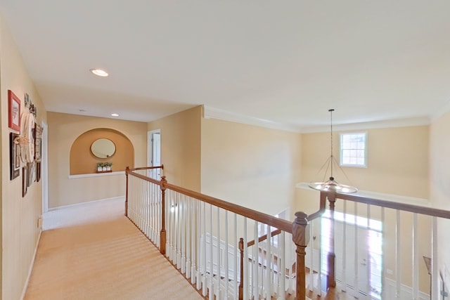 hallway featuring light carpet and crown molding