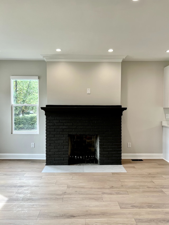 interior details featuring hardwood / wood-style floors and a fireplace