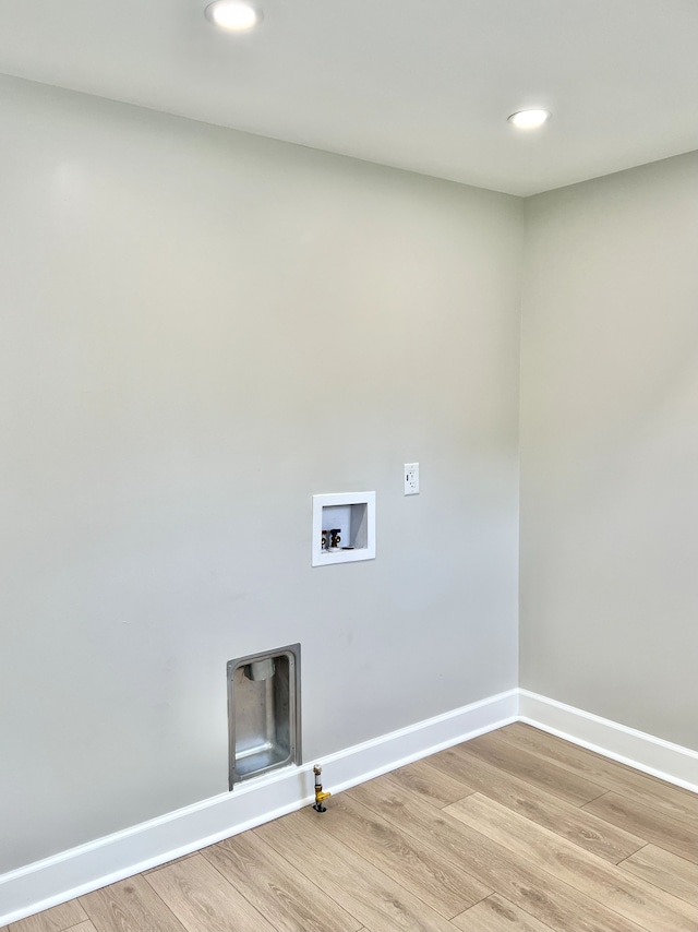 clothes washing area featuring light wood-type flooring, hookup for a washing machine, and hookup for a gas dryer