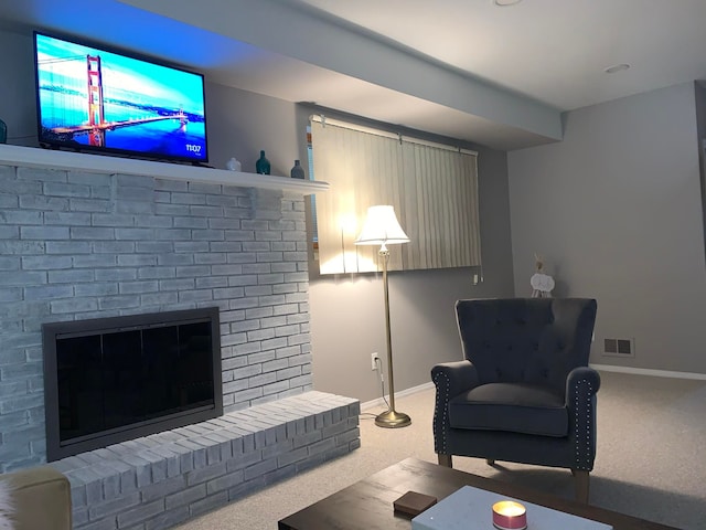 carpeted living room with a brick fireplace