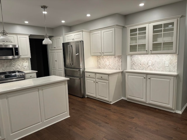 kitchen with decorative light fixtures, white cabinetry, dark hardwood / wood-style flooring, and stainless steel appliances