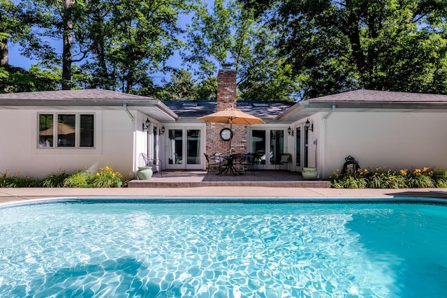 view of swimming pool featuring a patio and french doors