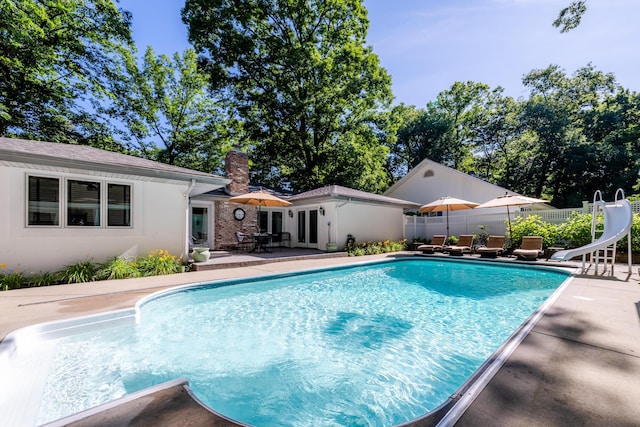 view of pool featuring a patio and a water slide