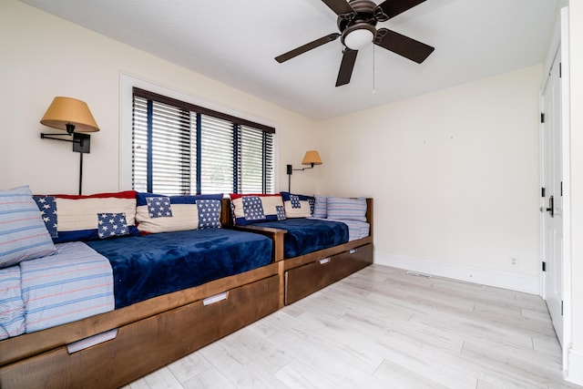 bedroom with ceiling fan and light hardwood / wood-style floors