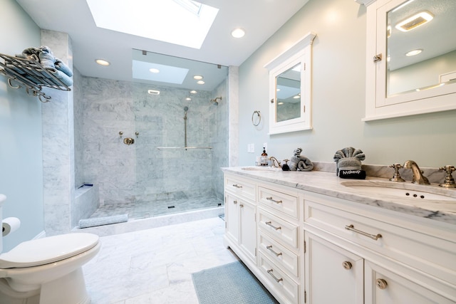 bathroom with toilet, tiled shower, a skylight, tile patterned floors, and vanity