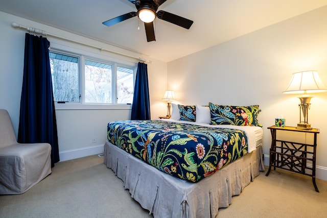 bedroom featuring light colored carpet and ceiling fan