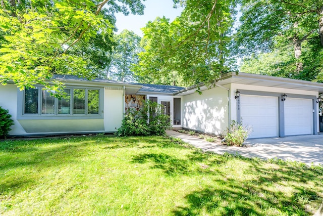 ranch-style house with a garage and a front lawn