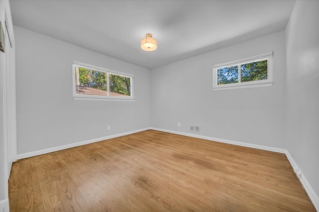 unfurnished room with hardwood / wood-style flooring