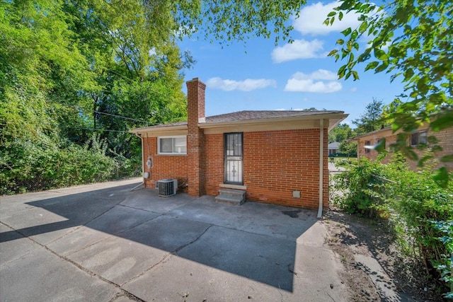 rear view of house featuring central air condition unit and a patio area