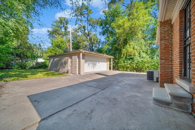 garage featuring central AC unit and a yard