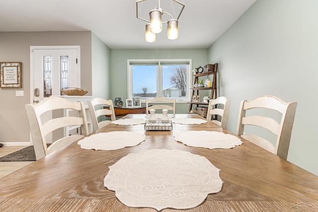 dining space featuring a wealth of natural light and a notable chandelier