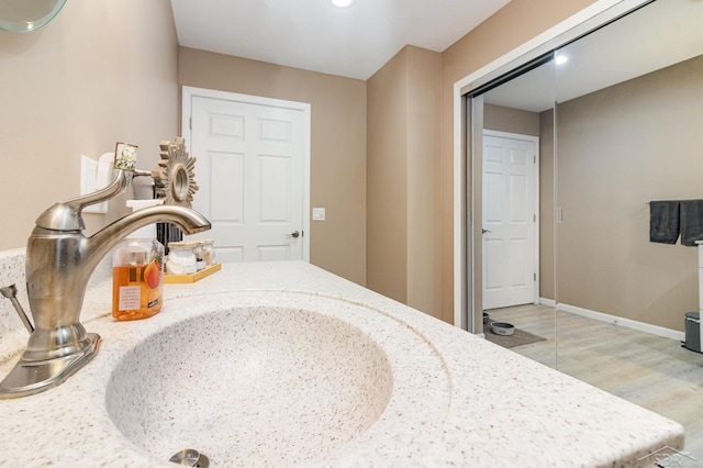 bathroom with wood-type flooring and vanity