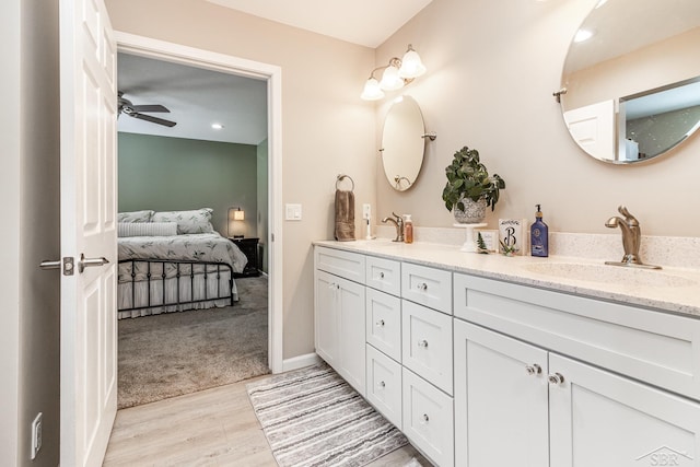 bathroom featuring hardwood / wood-style floors, ceiling fan, and vanity