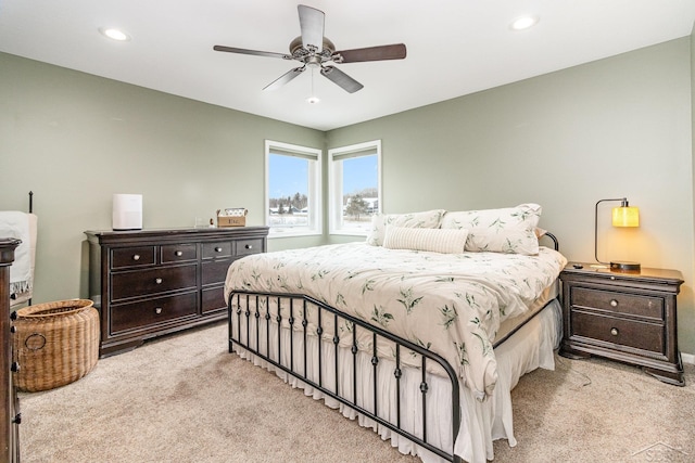 bedroom with ceiling fan and light carpet