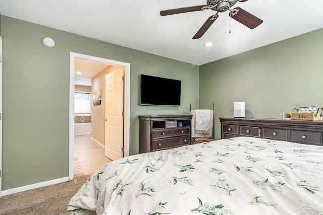 carpeted bedroom featuring ensuite bathroom and ceiling fan