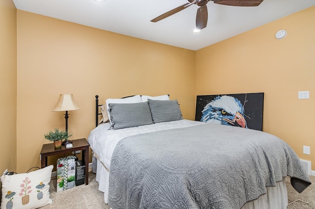 bedroom featuring ceiling fan and carpet