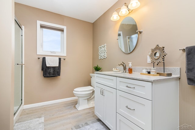 bathroom with an enclosed shower, toilet, vanity, and wood-type flooring