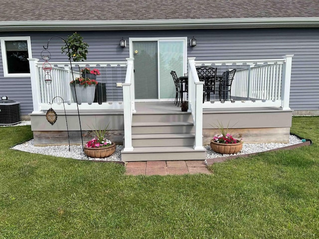 property entrance featuring central AC unit and a lawn