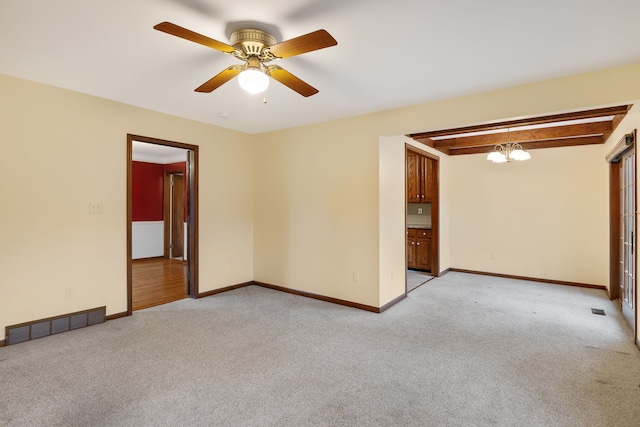 empty room with light colored carpet, visible vents, beamed ceiling, baseboards, and ceiling fan with notable chandelier