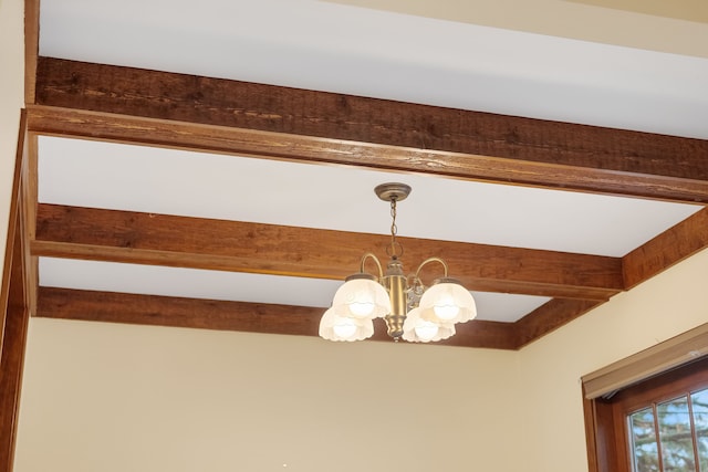 room details featuring a chandelier and beam ceiling