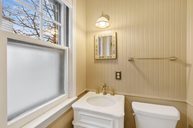 half bathroom with vanity and toilet