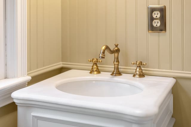 interior details featuring a decorative wall and vanity