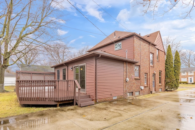 view of home's exterior with a wooden deck