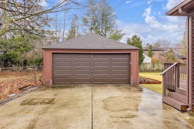 detached garage featuring fence