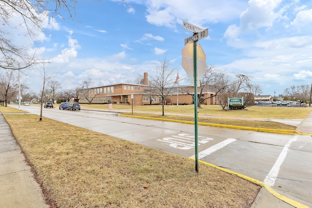 view of street featuring a residential view, curbs, and sidewalks