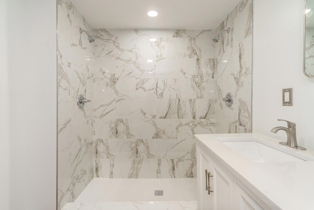 bathroom featuring vanity and tiled shower