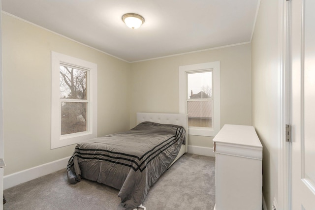 carpeted bedroom featuring crown molding and multiple windows