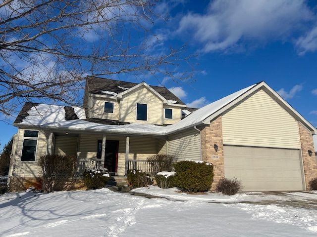 front facade with a porch and a garage