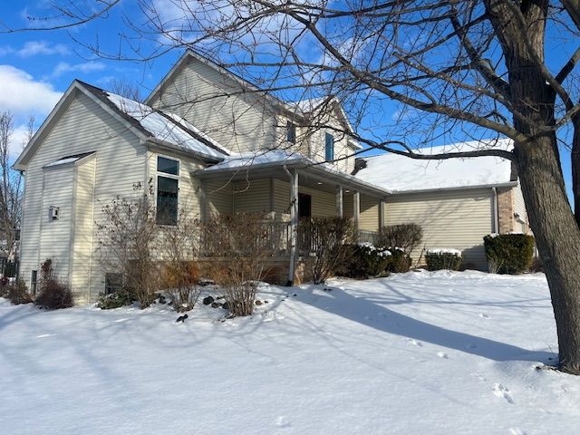 view of snowy exterior with a porch