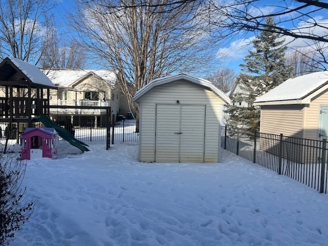 exterior space with a playground and a shed