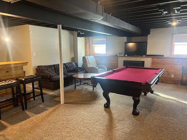 game room with wooden walls, pool table, and carpet