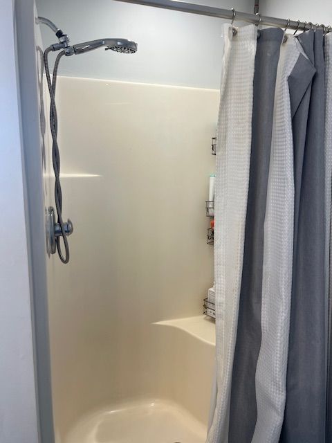 bathroom with shower / bath combination with curtain