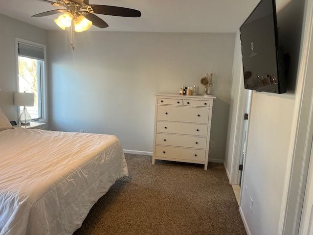 bedroom featuring ceiling fan and dark carpet