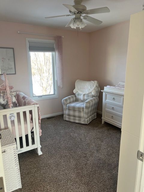 carpeted bedroom with ceiling fan