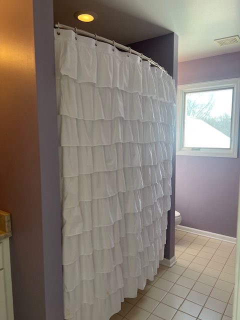 bathroom featuring tile patterned flooring, vanity, and toilet