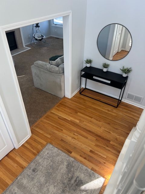 hallway with hardwood / wood-style flooring