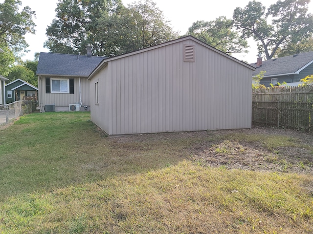 view of outdoor structure featuring cooling unit and a yard