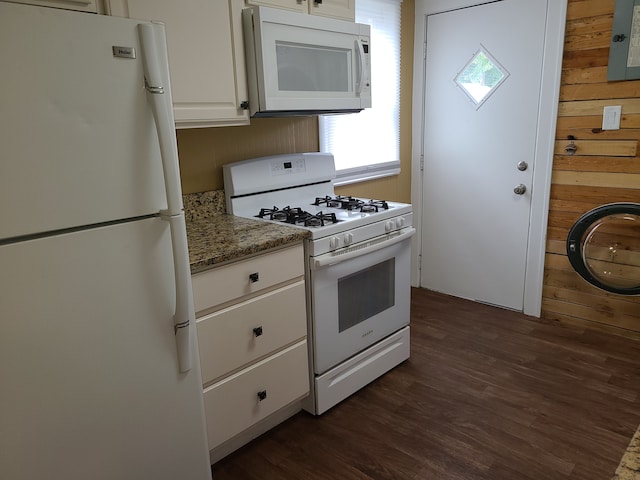 kitchen with white appliances, white cabinets, dark stone countertops, and electric panel