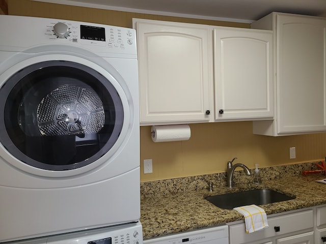 clothes washing area featuring sink and cabinets