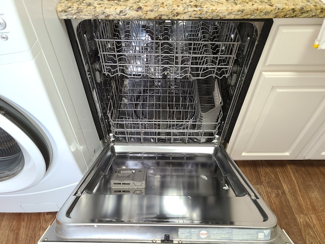 room details with dishwashing machine, white cabinets, and washer / dryer