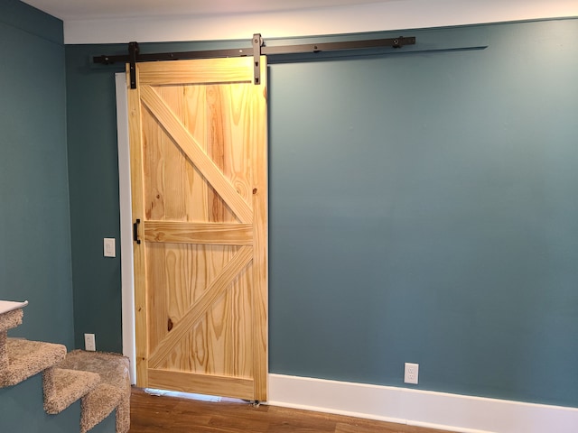 interior space with hardwood / wood-style flooring and a barn door