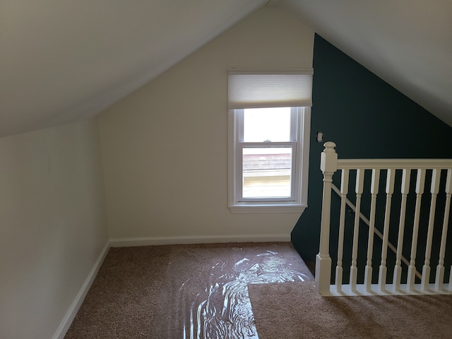 additional living space with lofted ceiling and carpet flooring