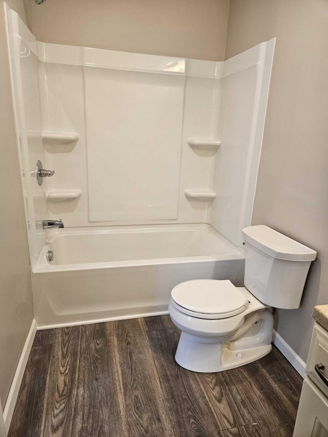 full bathroom with toilet, vanity, hardwood / wood-style flooring, and bathtub / shower combination