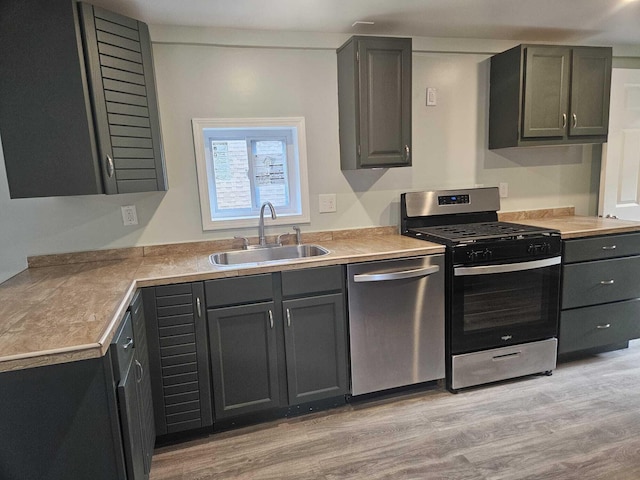 kitchen featuring sink, stainless steel appliances, and light hardwood / wood-style flooring