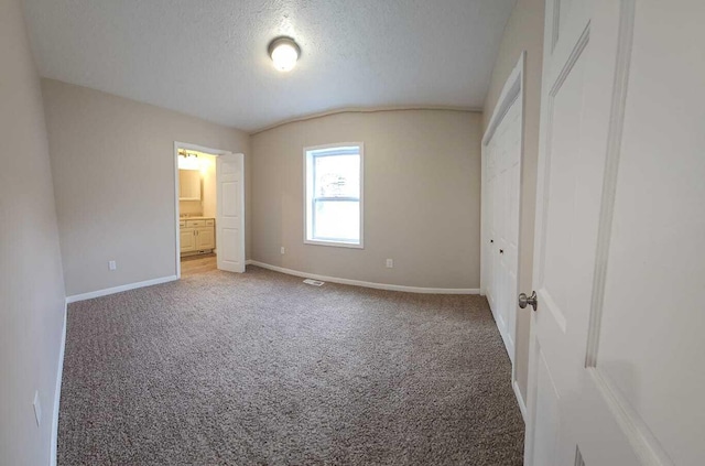 unfurnished bedroom featuring carpet flooring and a textured ceiling